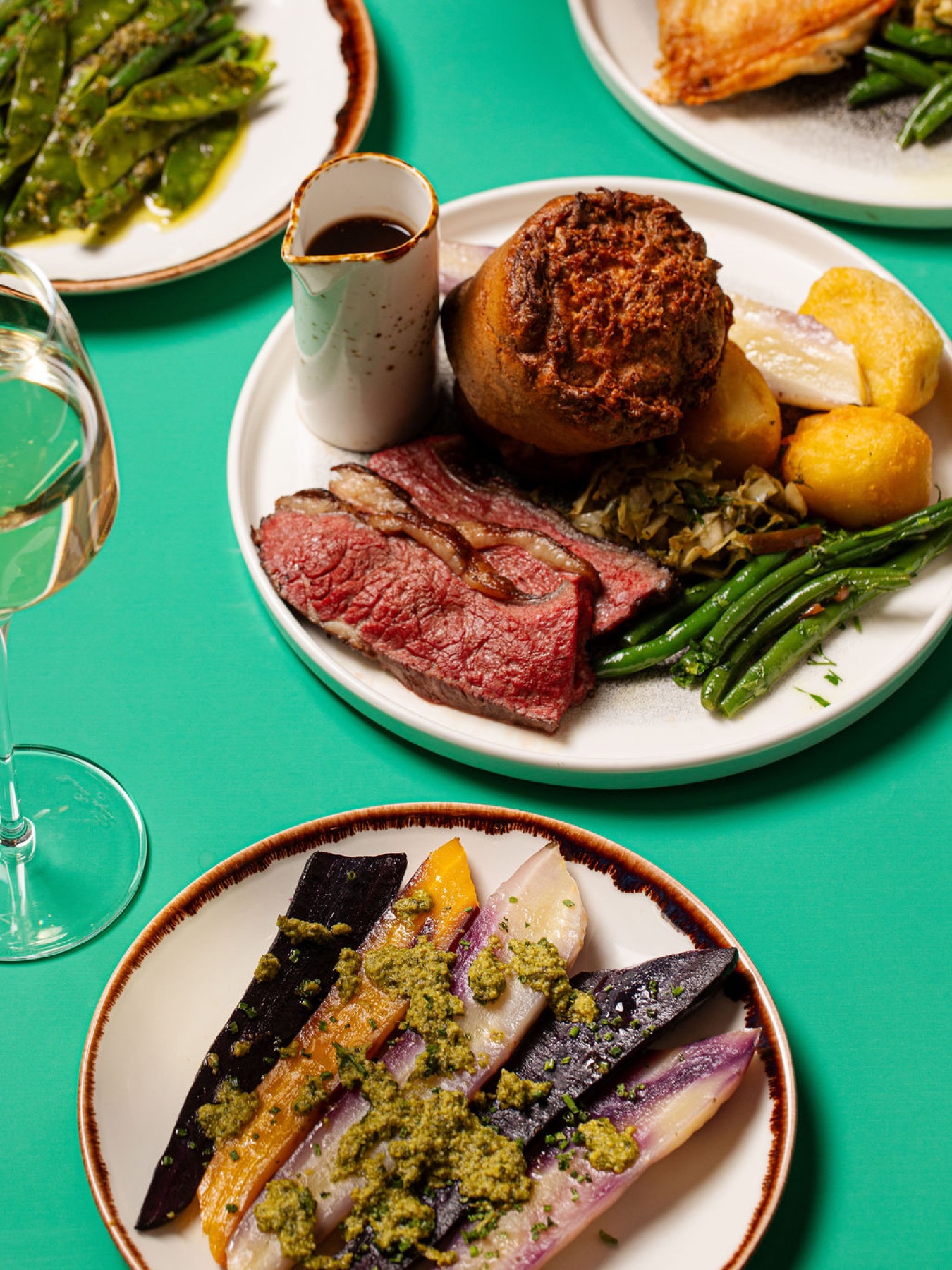 A plated course on a teal studio backdrop