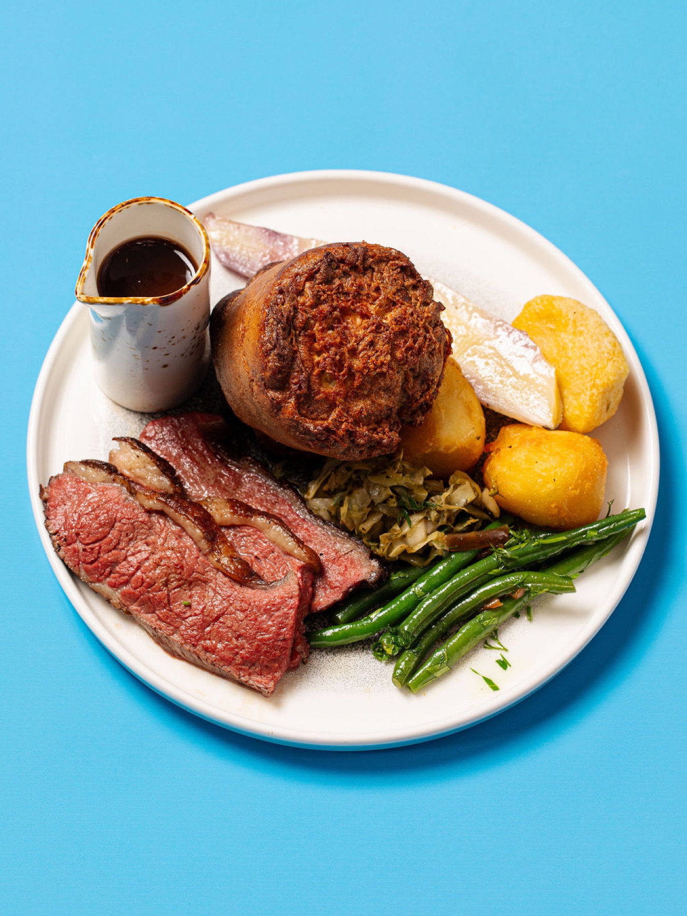 A Sunday roast on a pink studio backdrop