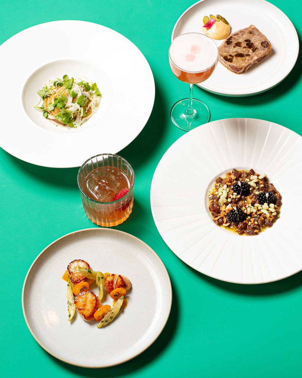 Plated dishes on an emerald studio backdrop