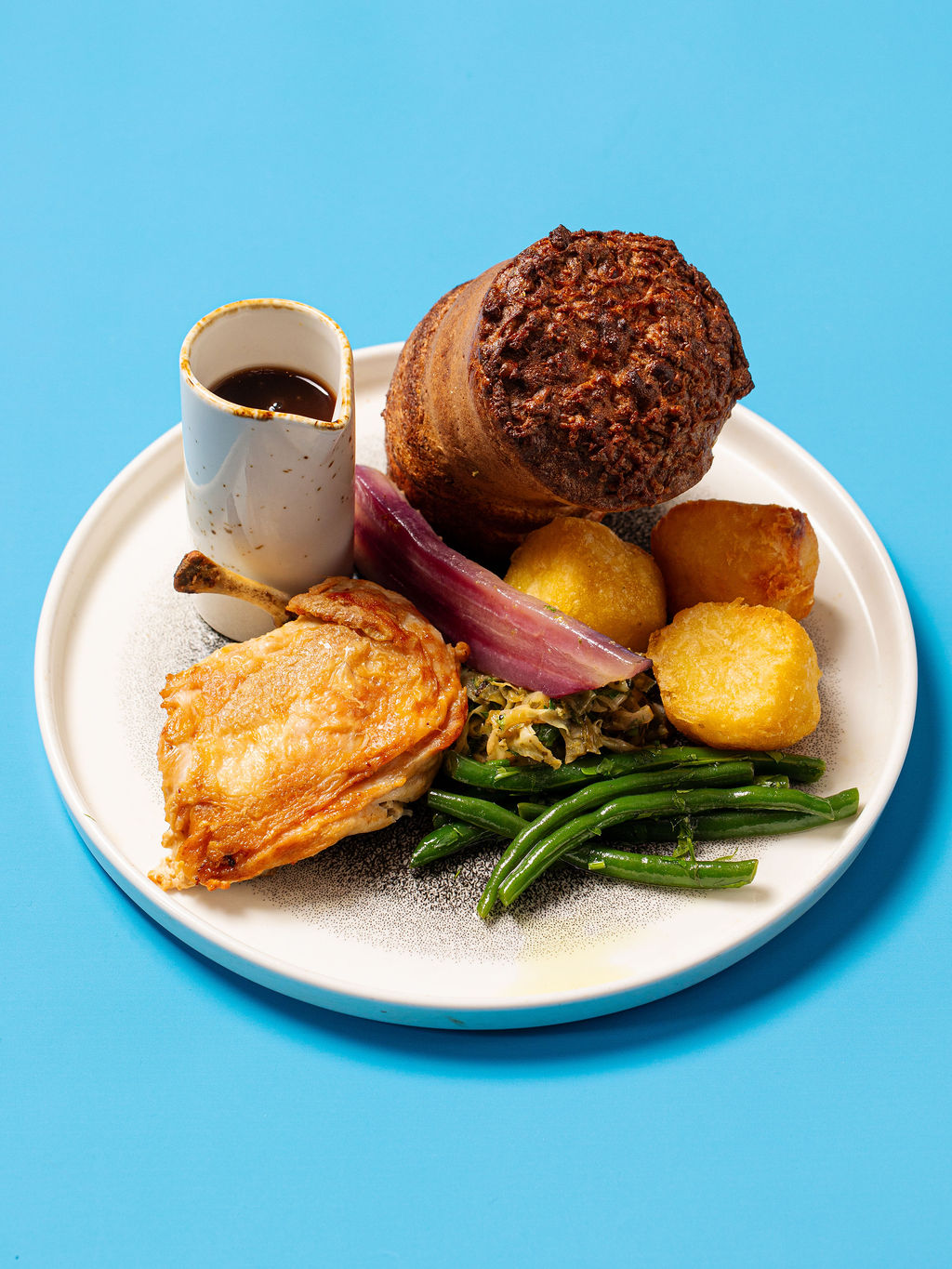 A Glaschu Sunday roast on a blue studio backdrop