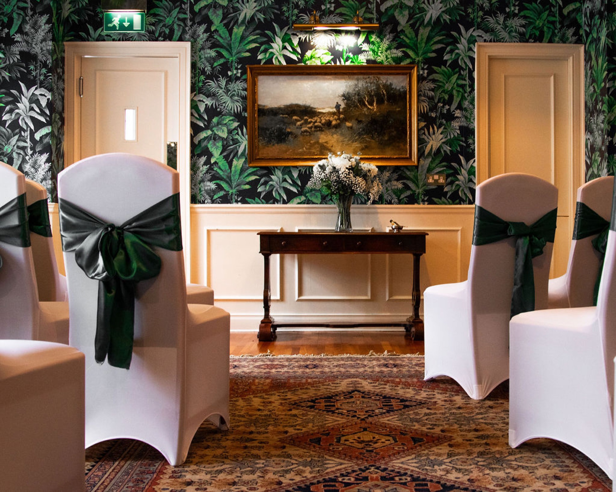 The ceremony room at Glaschu dressed with white chair covers and green sashes