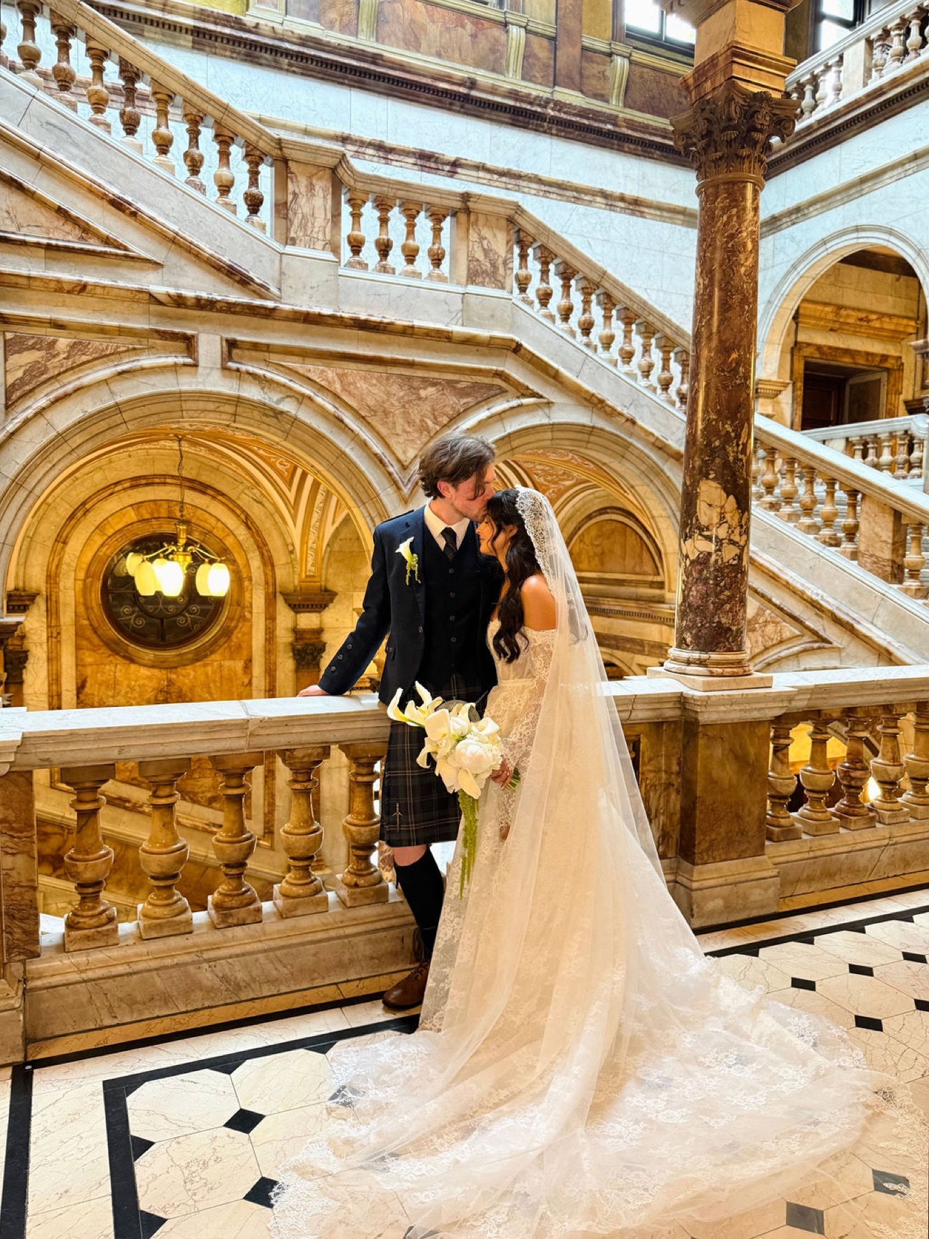 A bride and groom on the grand staircase at Glaschu, in the Western Club