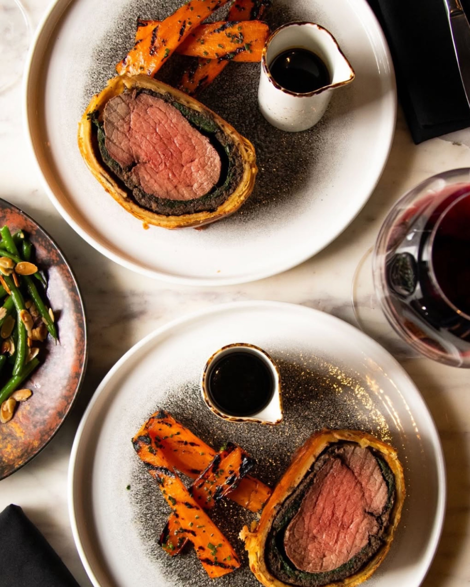 Two servings of the Beef Wellington with charred carrots, from above